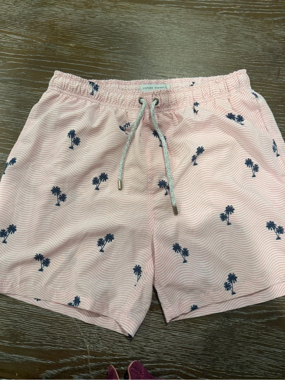 Pink swim trunks with palm trees